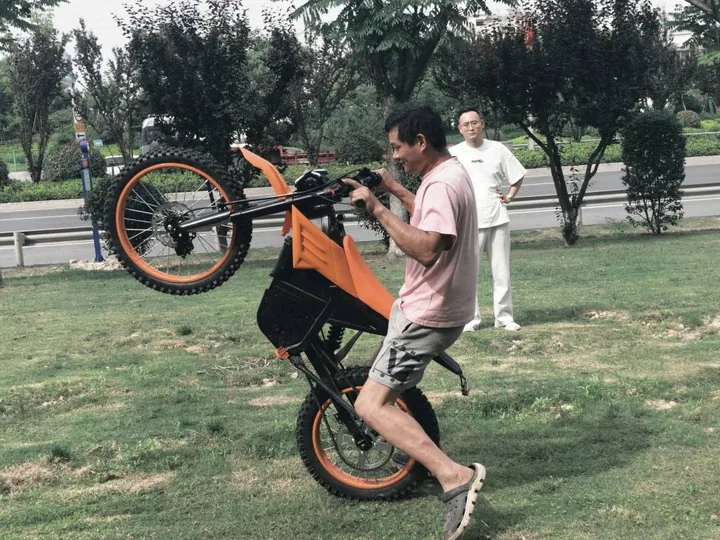 Electric dirt bike being handled during a ride test